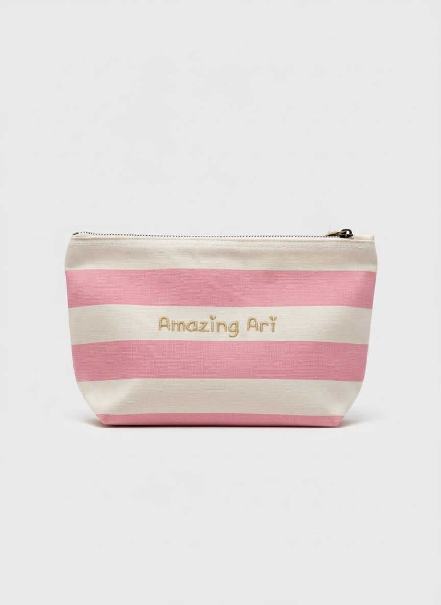 Stijlvolle toilettas met geborduurde tekst in het goud en roze strepen